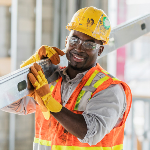 A strong construction worker carrying a heavy beam, representing the need for physical endurance and joint support in demanding jobs.